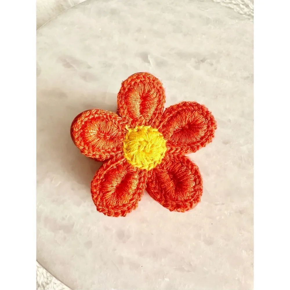 Orange and yellow crochet flower hair claw ￼